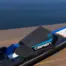 Close-up of a black and blue O'Brien ski boot binding on a ski with a blurred water background