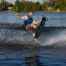 Skier lifts one ski while carving on O'Brien Pro Trac trick skis with Z9 bindings.