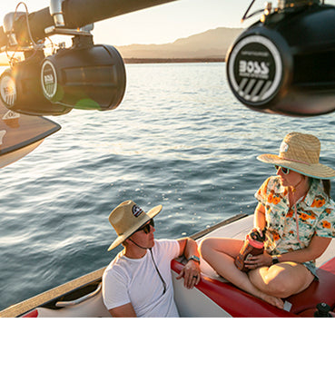 BOSS Marine wake-tower audio lifestyle BOSS marine wake-tower speakers above a family relaxing on a boat