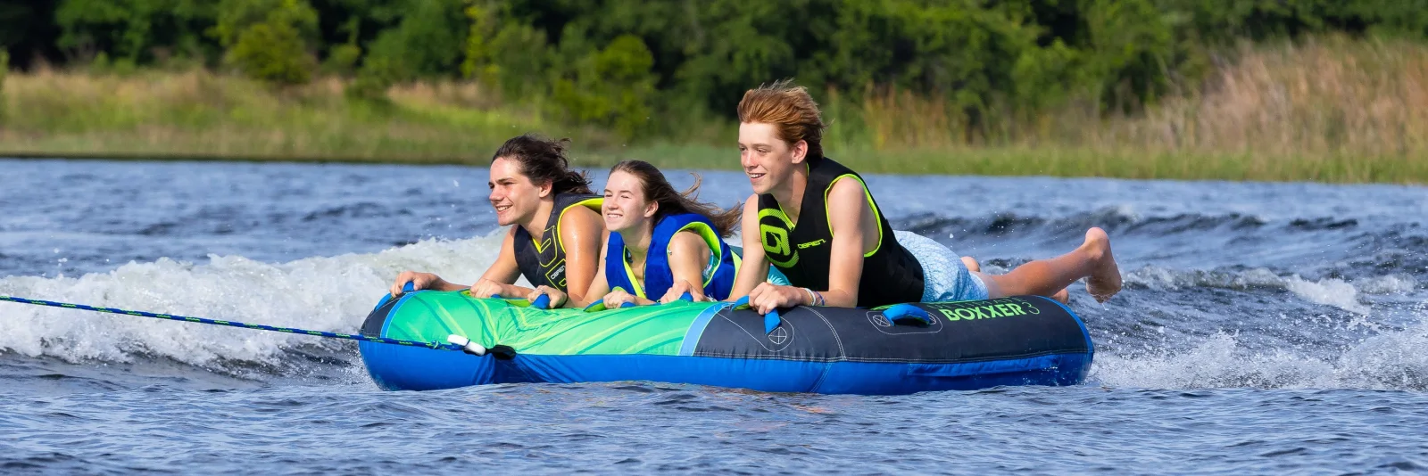 Three riders enjoying an O’Brien towable tube