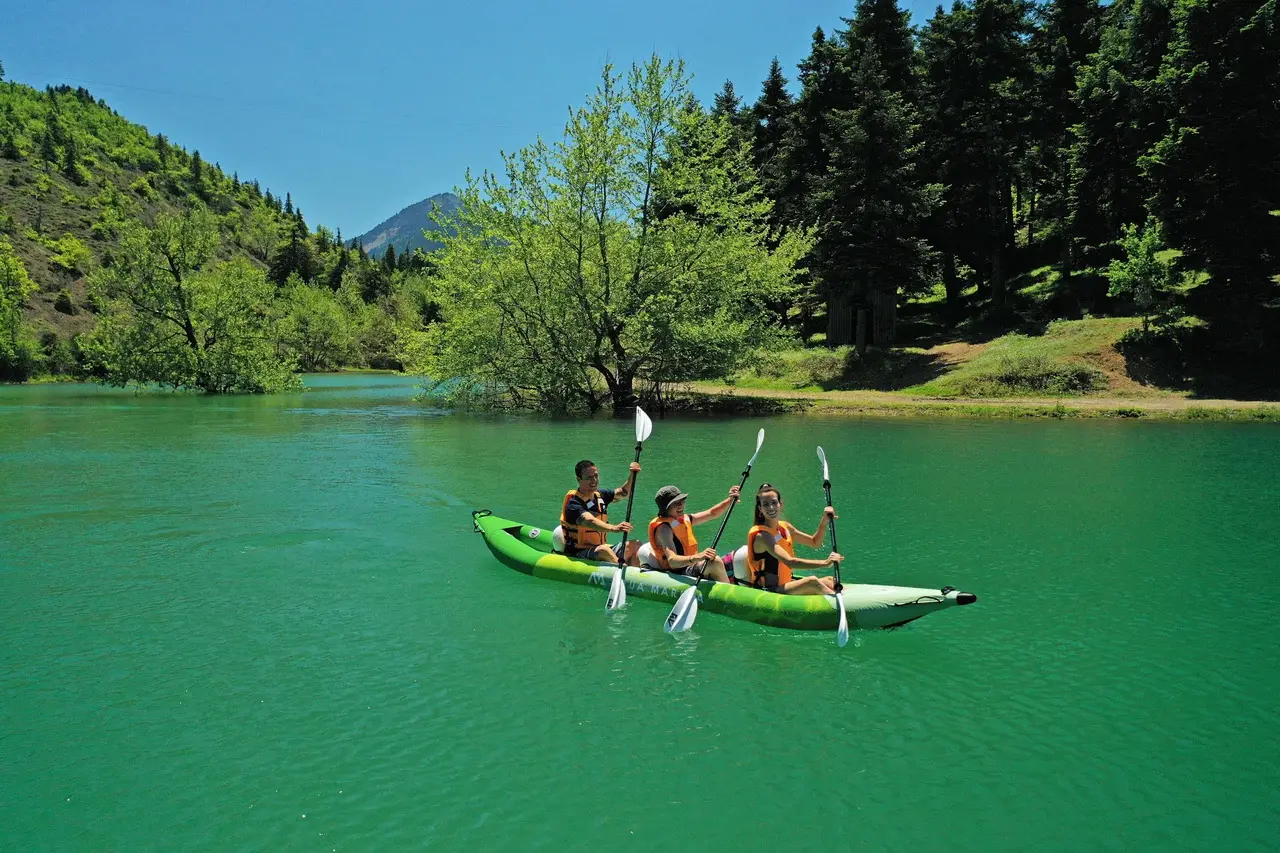 Aqua Marina BETTA 475 15′7″ Triple Kayak 1 Aqua Marina BETTA 475 - three paddlers in a kayak on clear green water