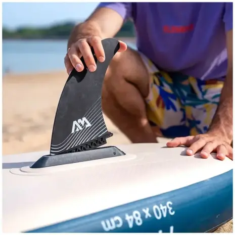 Aqua Marina SWIFT fin - person fitting a black fin to a paddle board Aqua Marina SWIFT fin - person fitting a black fin to a paddle board