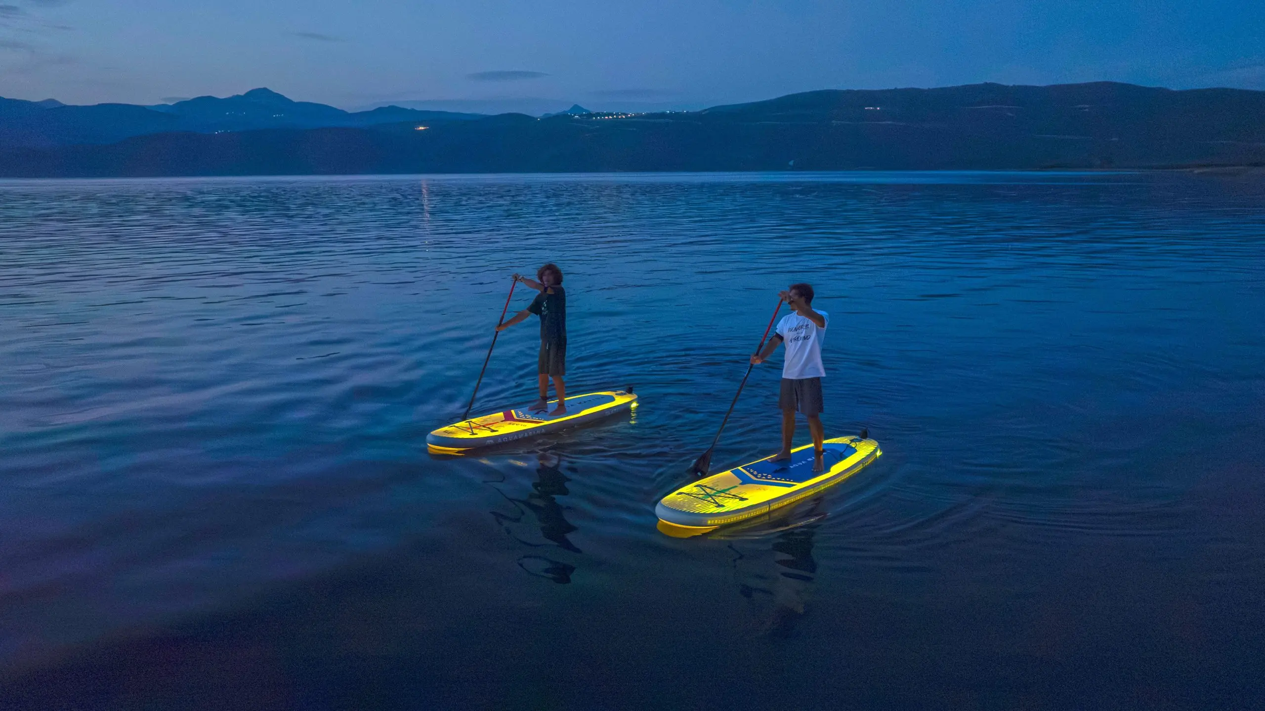 Aqua Marina Blaze 10'4" Illuminated Stand-Up Paddle Board 1 Aqua Marina paddle boards - two paddlers on illuminated boards at dusk