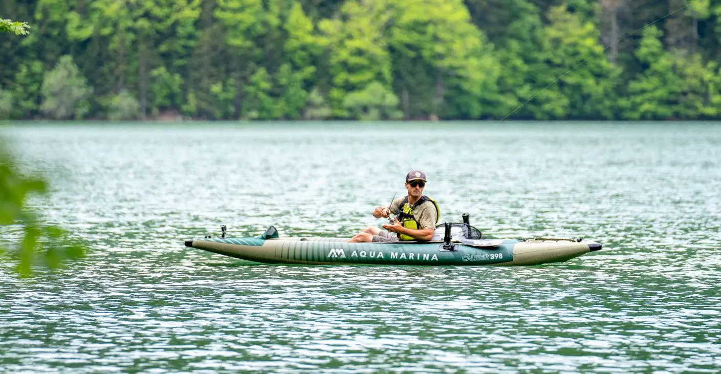 Aqua Marina CALIBER 13'1″ Angling Kayak 1 Aqua Marina CALIBER - angler seated in a kayak on a lake