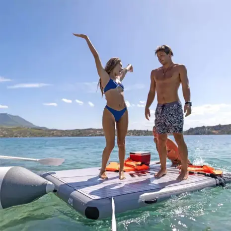 Aqua Marina Island Plus - two people standing on the platform on the water Aqua Marina Island Plus - two people standing on the platform on the water