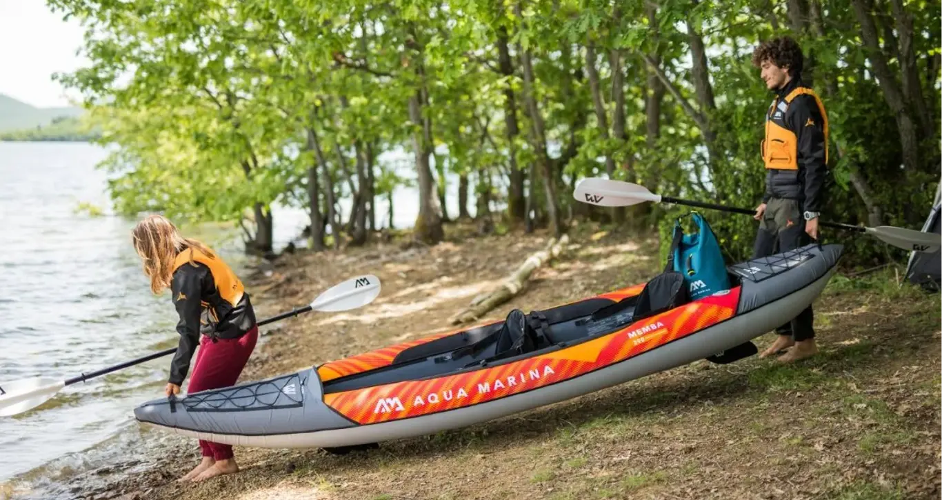 Aqua Marina MEMBA 390 12′10″ Double Kayak 1 Aqua Marina MEMBA 390 - two people carrying a kayak toward the water