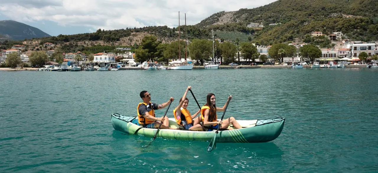 Aqua Marina RIPPLE 370 Triple Canoe 1 Aqua Marina RIPPLE 370 - three paddlers in a canoe near a coastal town