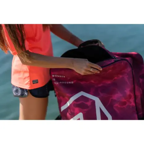 Aqua Marina Raspberry Bag - person holding the bag beside the water Aqua Marina Raspberry Bag - person holding the bag beside the water