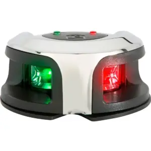 Attwood oval bi-colour navigation light - angled view of the polished housing with illuminated green and red lenses